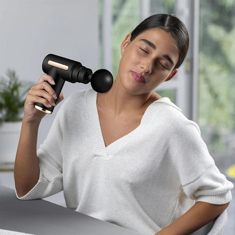 Femme_masse_son_cou_avec_le_pistolet_de_massage_-_mini_gold