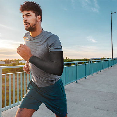 Un homme court à l'extérieur avec le manchon pour les bras - OxyFlow