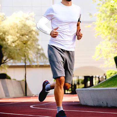 Un homme porte le manchon de compression bras - RegenArm durant une course à pied 